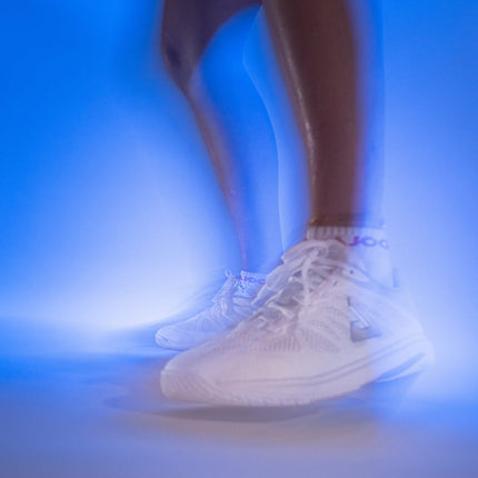 JOOLA SM4Sh table tennis shoes in white and grey, designed for training and competition, featuring breathable material and grip soles.